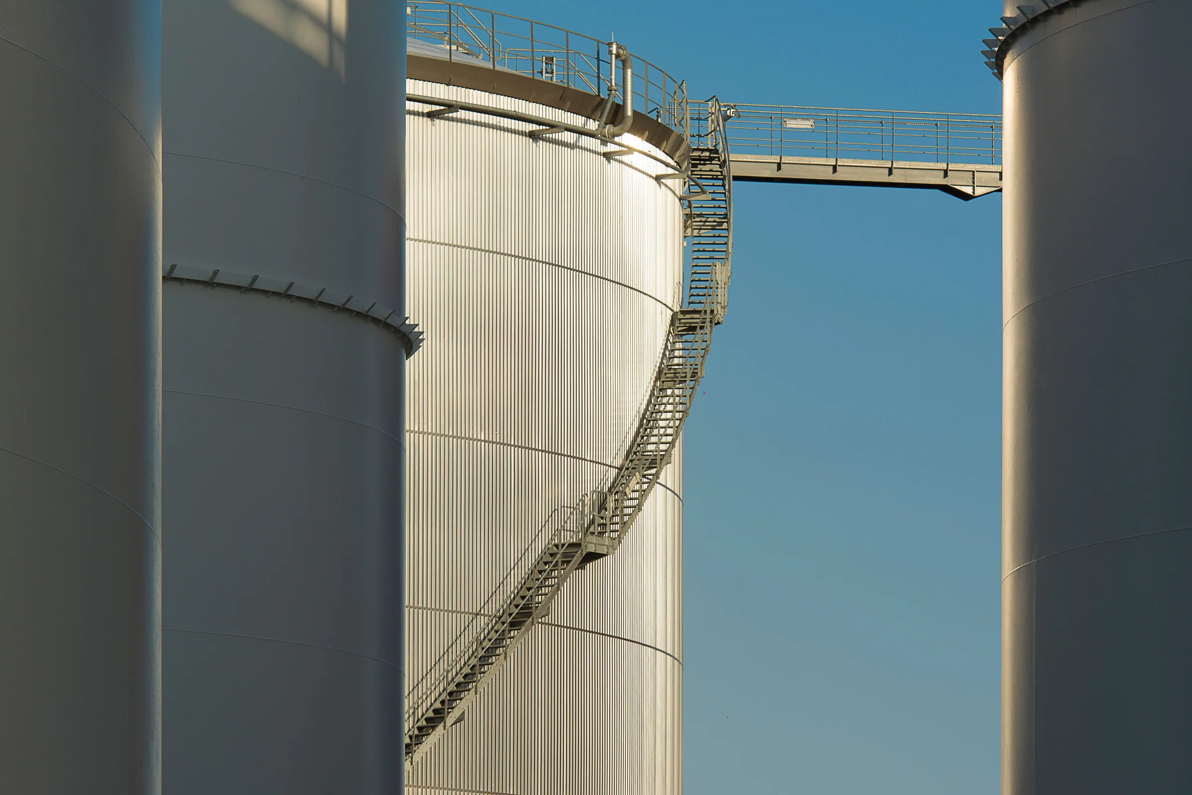Petroleum storage tanks at a terminal in the evening light